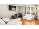 Comfortable room with hardwood flooring, offering flexible space for relaxing or entertaining at 995 Chimney Trace Way, Lawrenceville, GA 30045