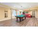 The finished basement features a pool table, hardwood floors and cozy seating area at 270 Annelise Park Dr, Fayetteville, GA 30214