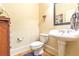 Powder room includes a decorative mirror, pedestal sink and wood floors at 270 Annelise Park Dr, Fayetteville, GA 30214