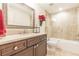 Elegant bathroom featuring granite counters, brown cabinets, and tiled shower and bath, showcasing modern design at 270 Annelise Park Dr, Fayetteville, GA 30214