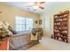 Comfortable bedroom with a large window, ceiling fan, and decorative touches at 270 Annelise Park Dr, Fayetteville, GA 30214