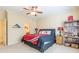 Cozy bedroom with ceiling fan, bookcase, and tasteful sports themed decor at 270 Annelise Park Dr, Fayetteville, GA 30214