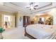 Spacious bedroom boasts a tray ceiling, neutral carpet, and wooden furniture, with an office through doorway at 270 Annelise Park Dr, Fayetteville, GA 30214