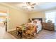 Charming bedroom with wood floors, ceiling fan, and adjoining room featuring a pool table at 270 Annelise Park Dr, Fayetteville, GA 30214