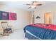 Comfortable bedroom with a ceiling fan, rocking chair, and South Carolina Gamecocks decor at 270 Annelise Park Dr, Fayetteville, GA 30214