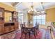 Formal dining room featuring a coffered ceiling, elegant chandelier, and antique wood furniture at 270 Annelise Park Dr, Fayetteville, GA 30214