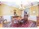 Traditional dining room with wood table, chairs, chandelier, and paneled walls and columns at 270 Annelise Park Dr, Fayetteville, GA 30214