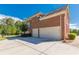 Side angle of a lovely brick home showcasing a three car garage and lawn at 270 Annelise Park Dr, Fayetteville, GA 30214