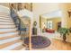 Open foyer featuring hardwood floors and a staircase with iron details at 270 Annelise Park Dr, Fayetteville, GA 30214