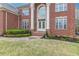 Inviting red brick home featuring a beautifully landscaped front yard at 270 Annelise Park Dr, Fayetteville, GA 30214