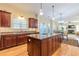 Open concept kitchen with island, granite countertops, stainless appliances, and backyard view at 270 Annelise Park Dr, Fayetteville, GA 30214