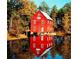 Vintage mill reflected in pond surrounded by fall foliage at 270 Annelise Park Dr, Fayetteville, GA 30214