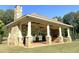 Outdoor pavilion with stone columns, ceiling fans, and a cozy fireplace and benches at 270 Annelise Park Dr, Fayetteville, GA 30214