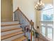 The entry staircase features hardwood stairs, iron spindles, and a view to the backyard at 270 Annelise Park Dr, Fayetteville, GA 30214
