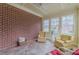 Cozy sunroom featuring exposed brick wall, tiled floors, and ample natural light at 270 Annelise Park Dr, Fayetteville, GA 30214