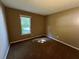The bedroom offers carpet and a window that brings in natural light at 2705 Rhoanoke Dr, Duluth, GA 30096