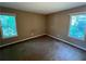 The bedroom has neutral carpet, fresh paint, and natural light from dual windows at 2705 Rhoanoke Dr, Duluth, GA 30096