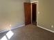 Bedroom featuring neutral walls, carpet, and a glimpse into an adjoined closet at 2705 Rhoanoke Dr, Duluth, GA 30096