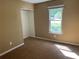 Bedroom features neutral paint and trim, a window, carpet and a closet at 2705 Rhoanoke Dr, Duluth, GA 30096