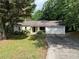 Charming single-story home with a two-car garage surrounded by lush greenery at 2705 Rhoanoke Dr, Duluth, GA 30096