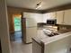 Functional kitchen featuring white cabinets, laminate counters and appliances at 2705 Rhoanoke Dr, Duluth, GA 30096