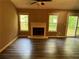 The spacious living room boasts sleek floors, a fireplace, and sliding glass doors at 2705 Rhoanoke Dr, Duluth, GA 30096