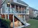 Enjoy this back porch area with overhead screened in porch, back patio and staircase at 3250 Seven Oaks Dr, Cumming, GA 30041