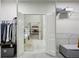 Walk-in closet featuring ample storage and an ensuite bathroom with a view of the bedroom at 3250 Seven Oaks Dr, Cumming, GA 30041