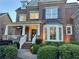 Charming brick home featuring a covered front porch with classic white pillars and manicured landscaping at 3250 Seven Oaks Dr, Cumming, GA 30041