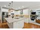Bright, updated kitchen with a large island, stainless steel appliances, and open to living area at 3250 Seven Oaks Dr, Cumming, GA 30041