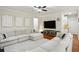 Modern living room with a large sectional couch, TV, and hardwood floors at 3250 Seven Oaks Dr, Cumming, GA 30041