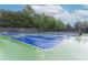Well-maintained tennis court with professional surfacing, ready for a match at 3250 Seven Oaks Dr, Cumming, GA 30041