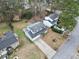 An aerial perspective of a two-story home with a driveway and a well-kept yard surrounded by mature trees and landscaping at 4608 Rosemear Ct, Norcross, GA 30093
