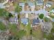 An aerial view displays a residential area with tidy homes, green lawns, and tree-lined streets on a sunny day at 4608 Rosemear Ct, Norcross, GA 30093