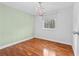 The bedroom has hardwood flooring, a chandelier, and a window at 4608 Rosemear Ct, Norcross, GA 30093