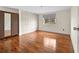 Bedroom with hardwood floors, a window, and built in closet storage at 4608 Rosemear Ct, Norcross, GA 30093