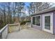 View of a deck overlooking a green yard with a door leading inside at 4608 Rosemear Ct, Norcross, GA 30093