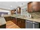 Well-lit kitchen with stainless steel appliances, granite countertops, and hardwood floors at 4608 Rosemear Ct, Norcross, GA 30093