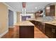 Open kitchen with island, stainless steel hood, and access to the living area at 4608 Rosemear Ct, Norcross, GA 30093