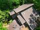 Aerial view showcasing the roof, surrounding greenery, and a pond near the deck at 605 Ga 120 Hwy, Roswell, GA 30075
