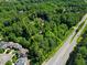 Aerial view shows the wooded lot, property lines and proximity to the main road at 605 Ga 120 Hwy, Roswell, GA 30075