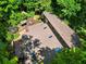 Aerial view of the property, highlighting the extensive decks, gazebo and mature trees at 605 Ga 120 Hwy, Roswell, GA 30075