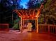 Beautiful patio and outdoor entertaining area with grill and custom-built pergola surrounded by natural forest at 605 Ga 120 Hwy, Roswell, GA 30075