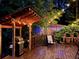 Outdoor kitchen area with grill and bar seating on wooden deck, perfect for outdoor entertaining at 605 Ga 120 Hwy, Roswell, GA 30075