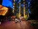 Evening view of back deck with multiple seating areas and decorative string lights at 605 Ga 120 Hwy, Roswell, GA 30075