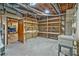 Unfinished basement with shelving, laundry sink, and exposed pipes, perfect for storage at 605 Ga 120 Hwy, Roswell, GA 30075