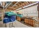 Unfinished basement with storage, exposed pipes, and wood cabinets at 605 Ga 120 Hwy, Roswell, GA 30075