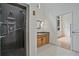 Modern bathroom features a granite shower, wooden vanity and bright natural light at 605 Ga 120 Hwy, Roswell, GA 30075
