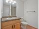 Bathroom featuring a single sink vanity with light wood cabinets and a mirror, complemented by tile flooring at 605 Ga 120 Hwy, Roswell, GA 30075