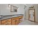 Bathroom features wooden vanity, granite countertops, large mirror and ample lighting at 605 Ga 120 Hwy, Roswell, GA 30075